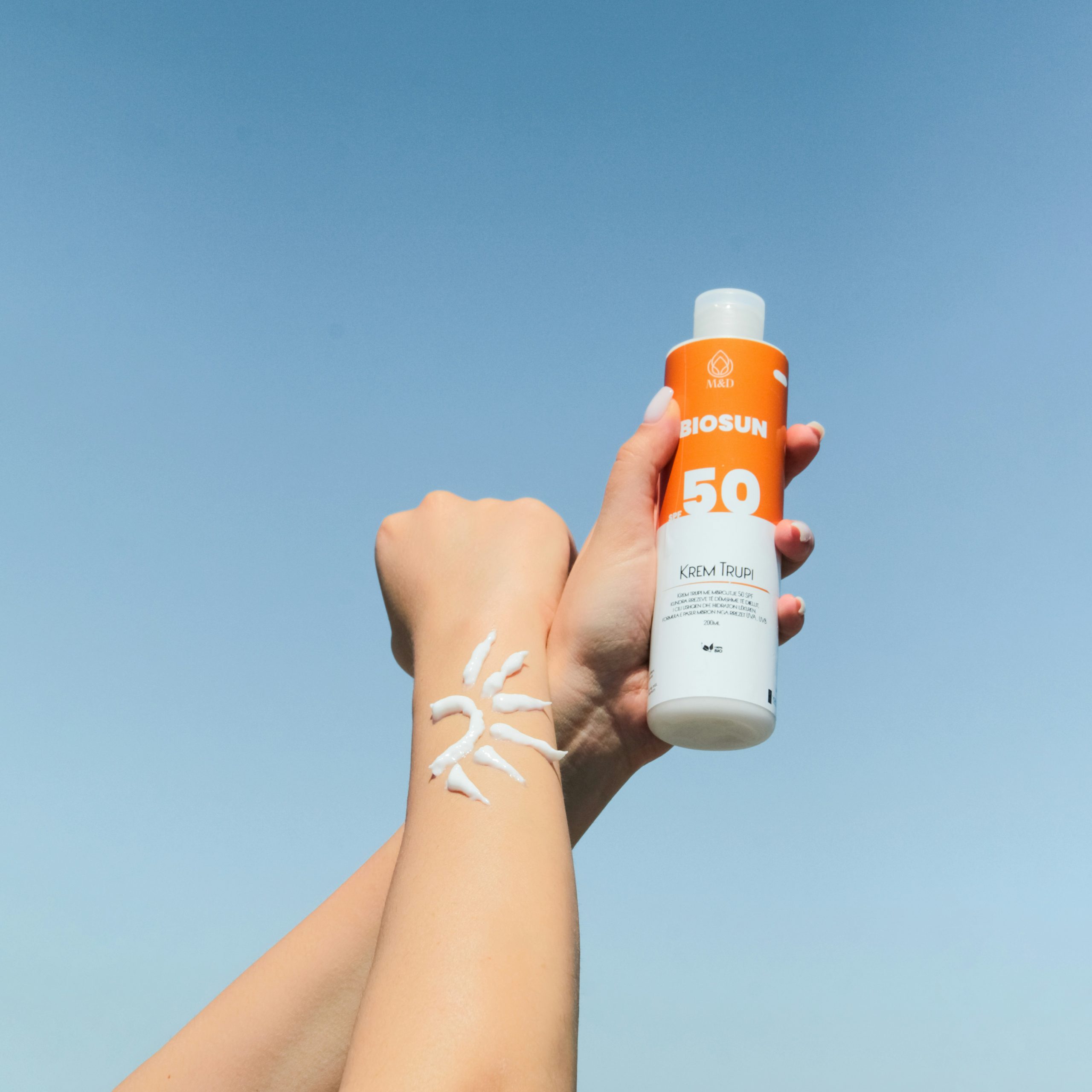 Applying sunscreen to arms